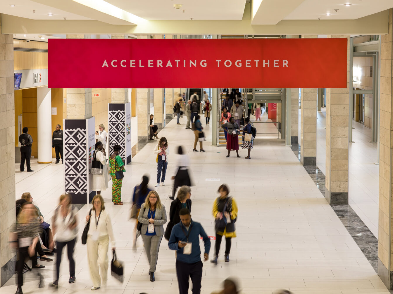 A banner reads "Accelerating Together" at the International Maternal and Newborn Health Conference 2023